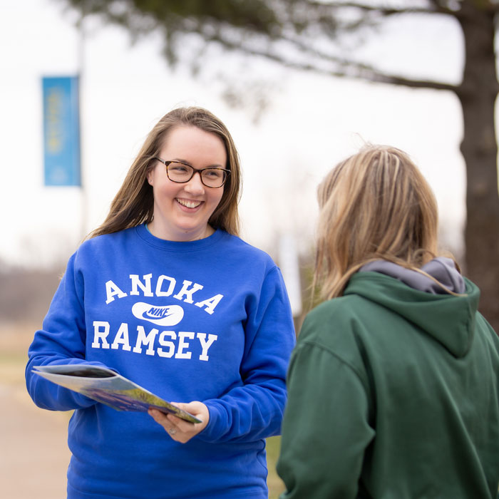 Female Admissions Staff Member Smiling at Prospective Student