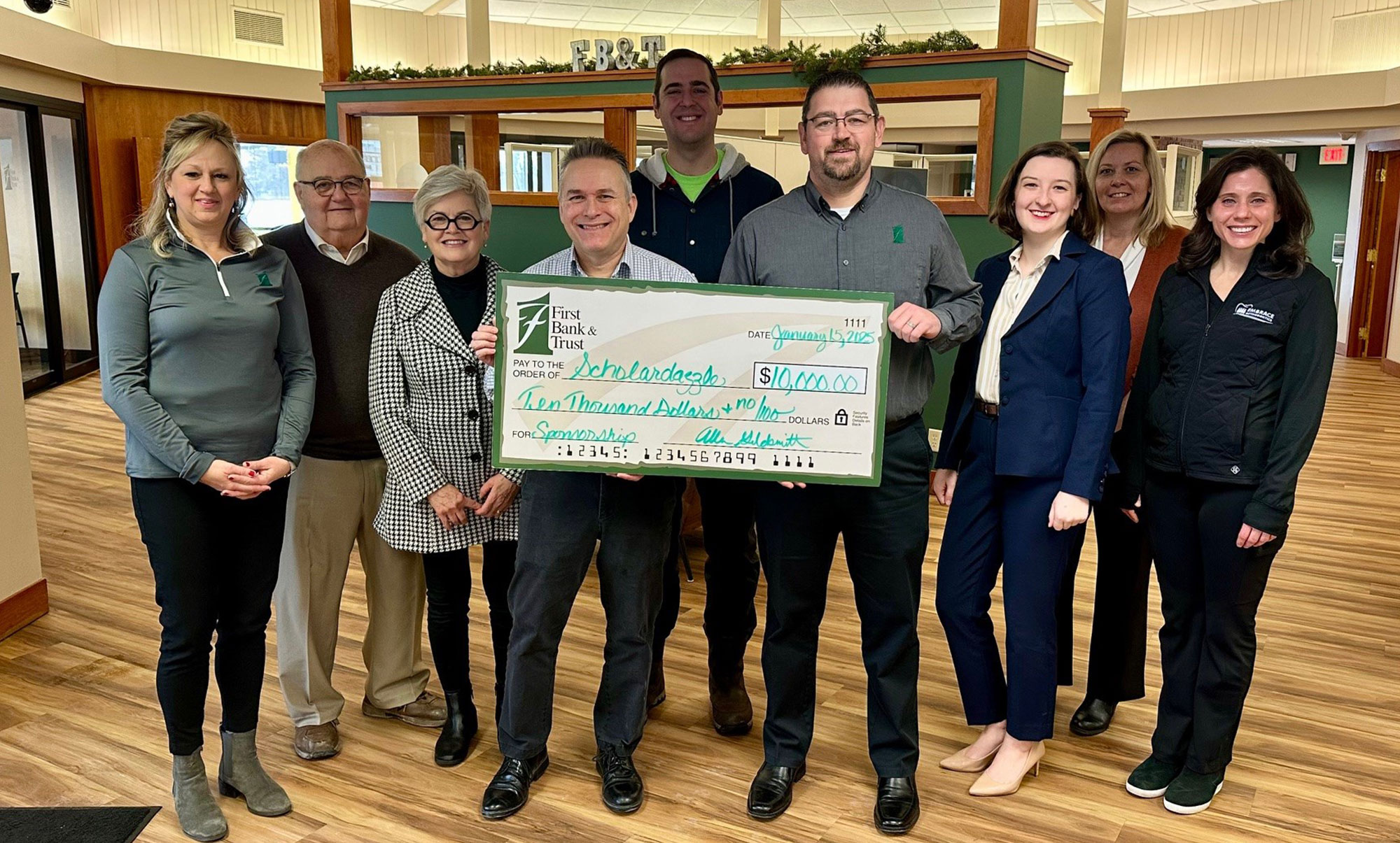 Group Standing Holding a Large Donation Check from First National Bank