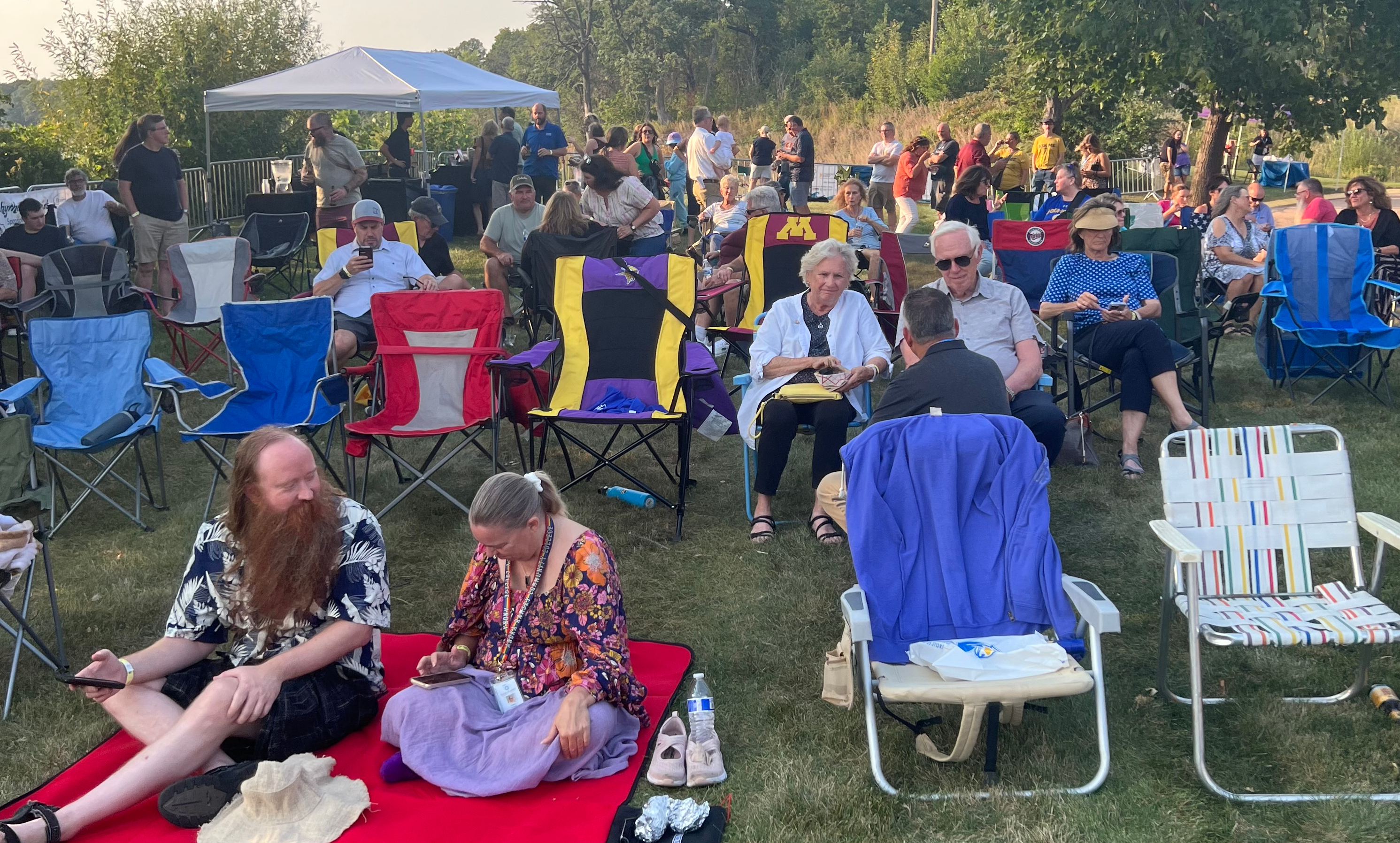 Crowd Attending Rhythm of the Rapids Event Sitting on Campus Lawn