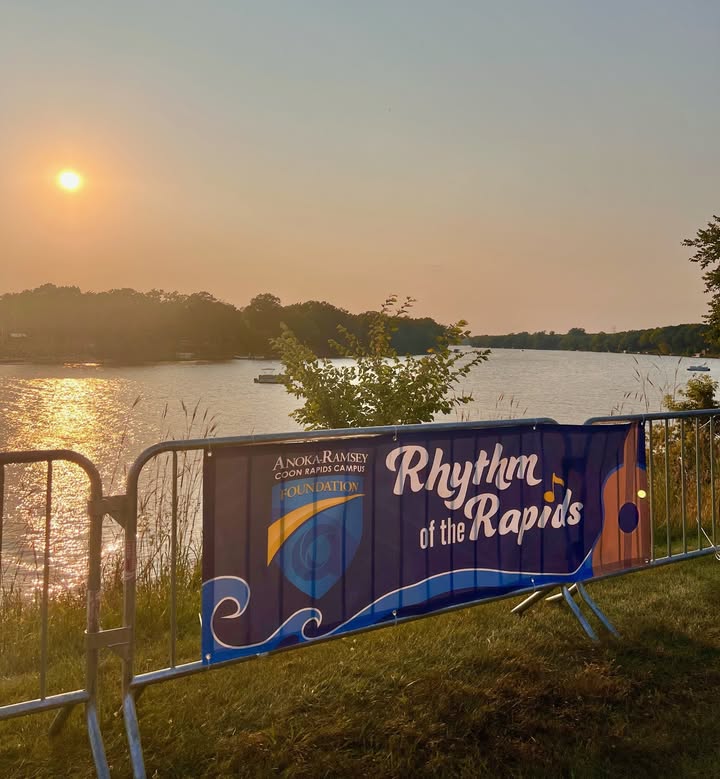 Rhythm of Rapids Sign with Sunset Mississippi River