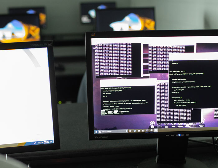 computer monitor displaying programming code in a computer science lab