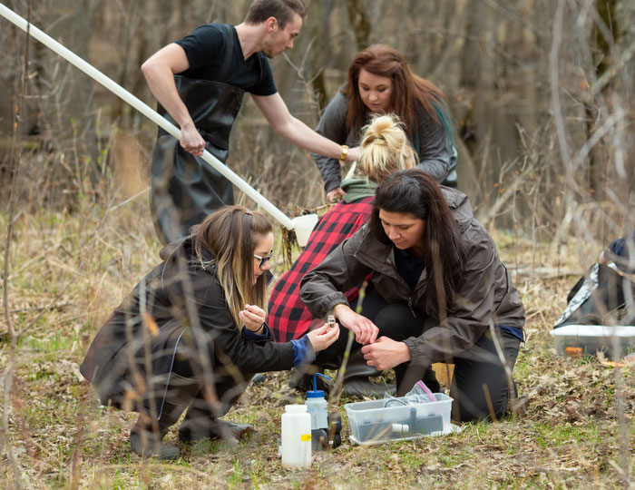 Group working outdoors with equipment