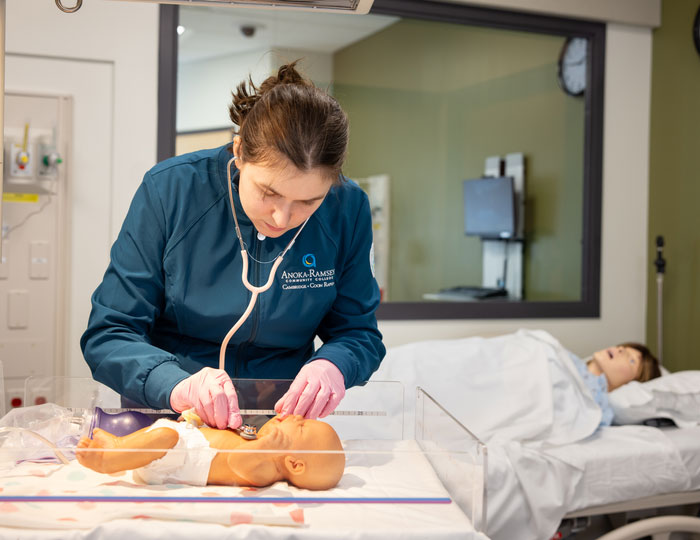 Nursing student practices infant care in Anoka‑Ramsey simulation lab