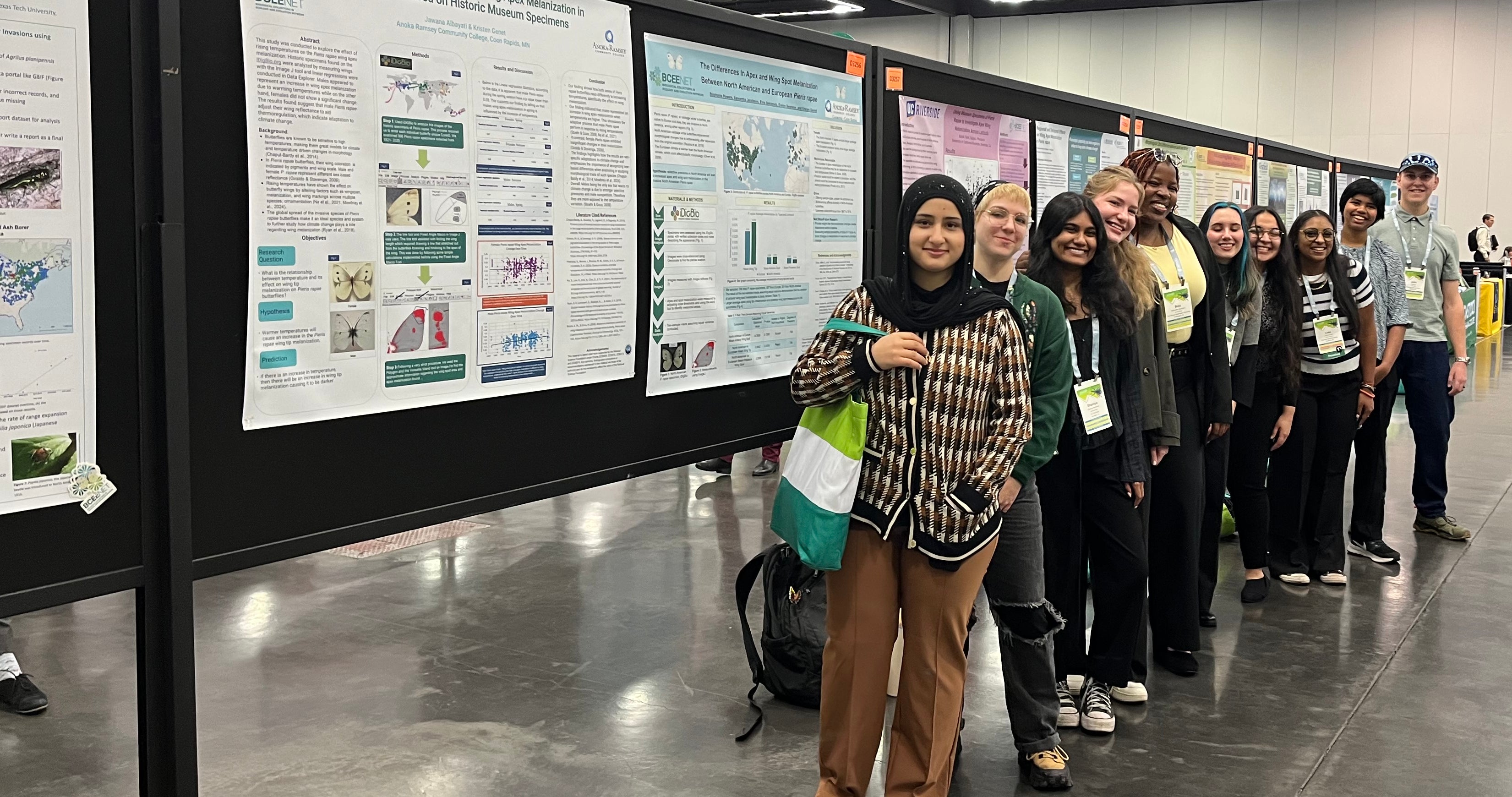 Group of students standing in front of large posters at National Conference event
