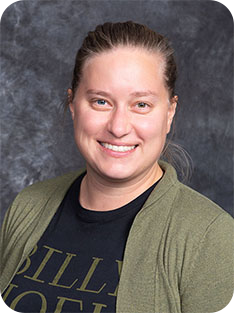 Individual wearing gray sweater over black t-shirt