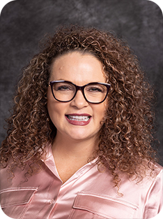 Individual wearing pink shirt and glasses