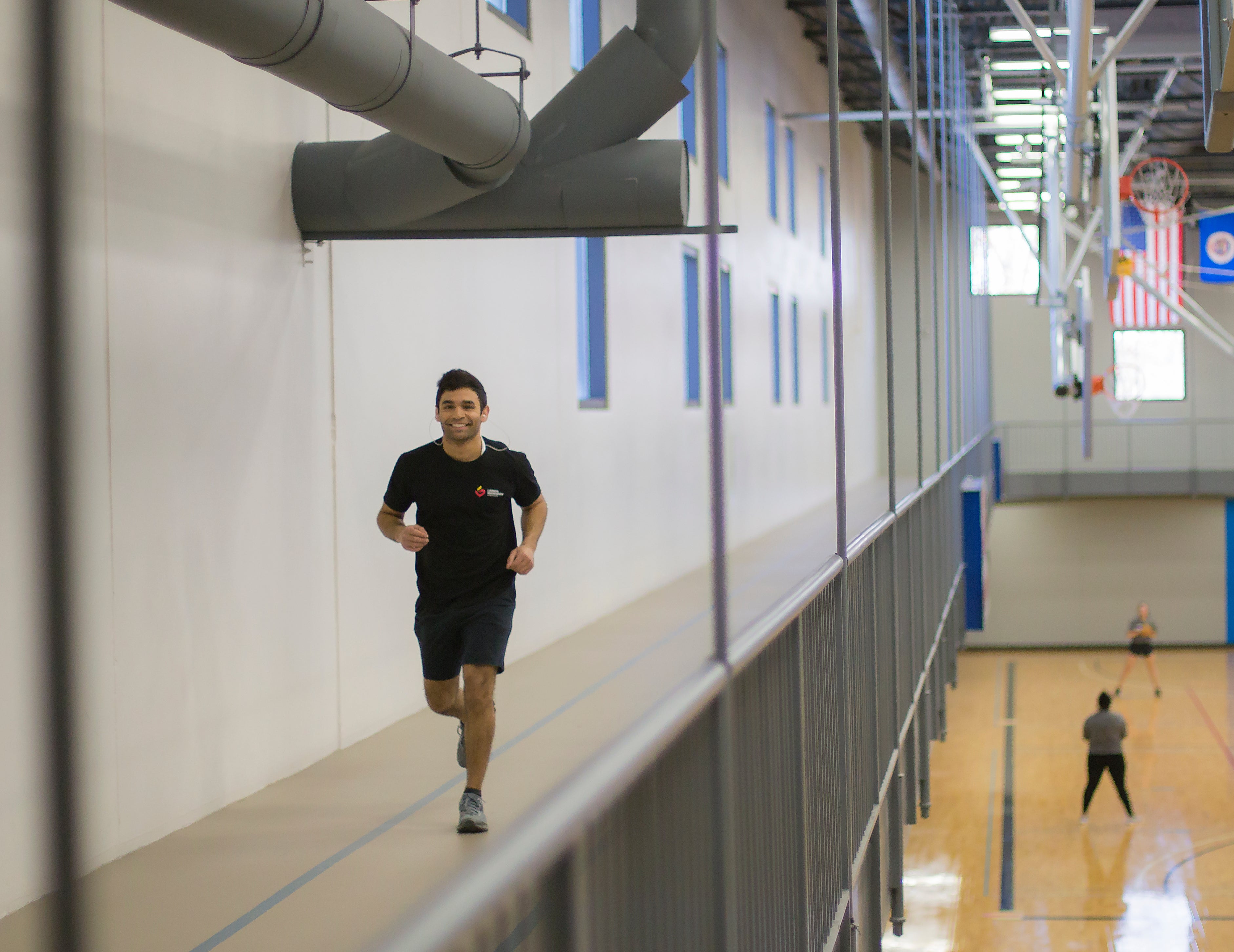 Individual running on elevated track.